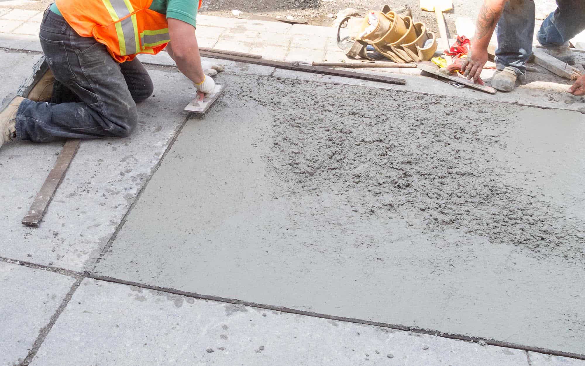 Worker outside smoothing repaired concrete